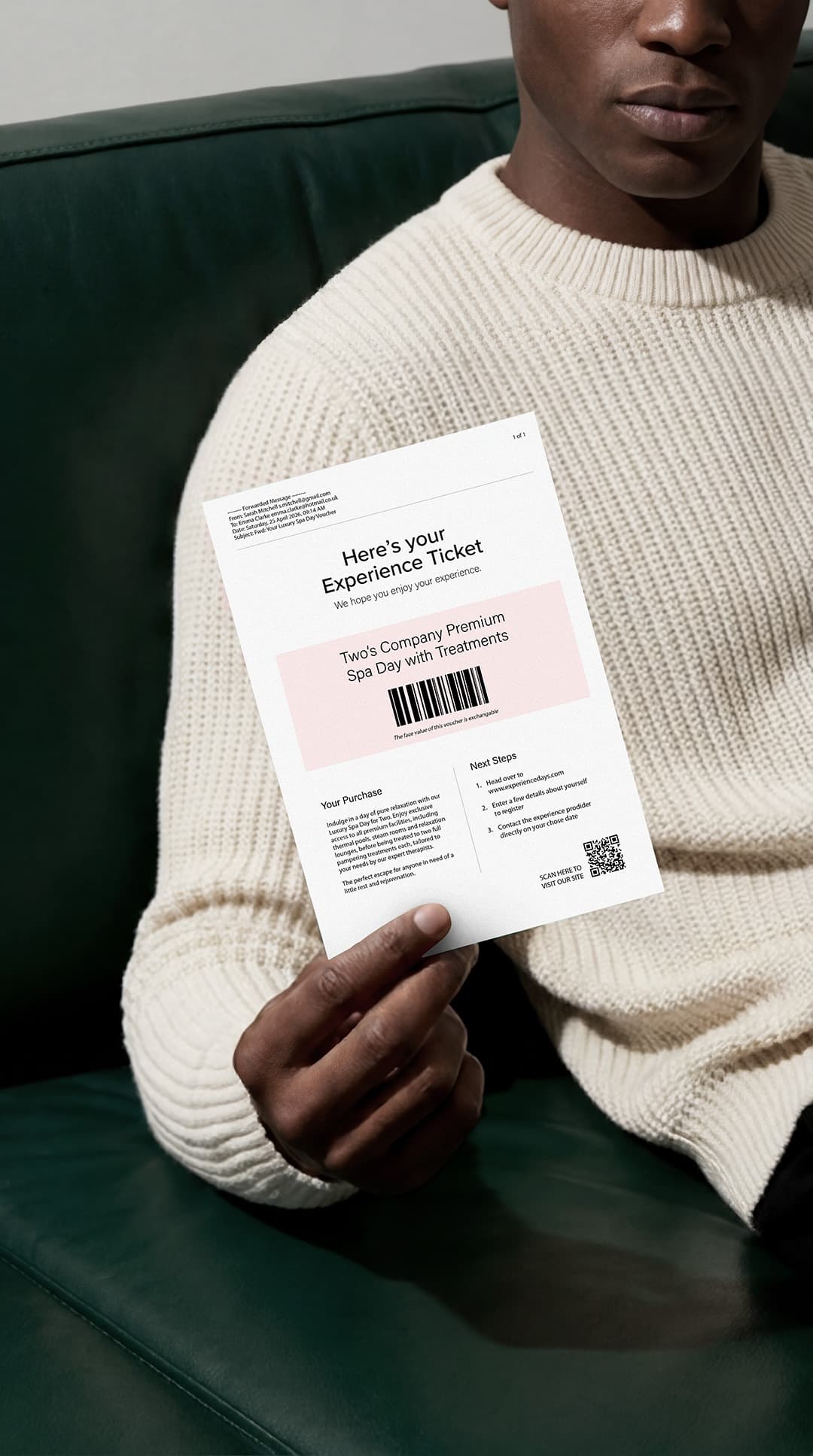 A plain printed experience voucher for a spa day, held in a lifestyle setting.