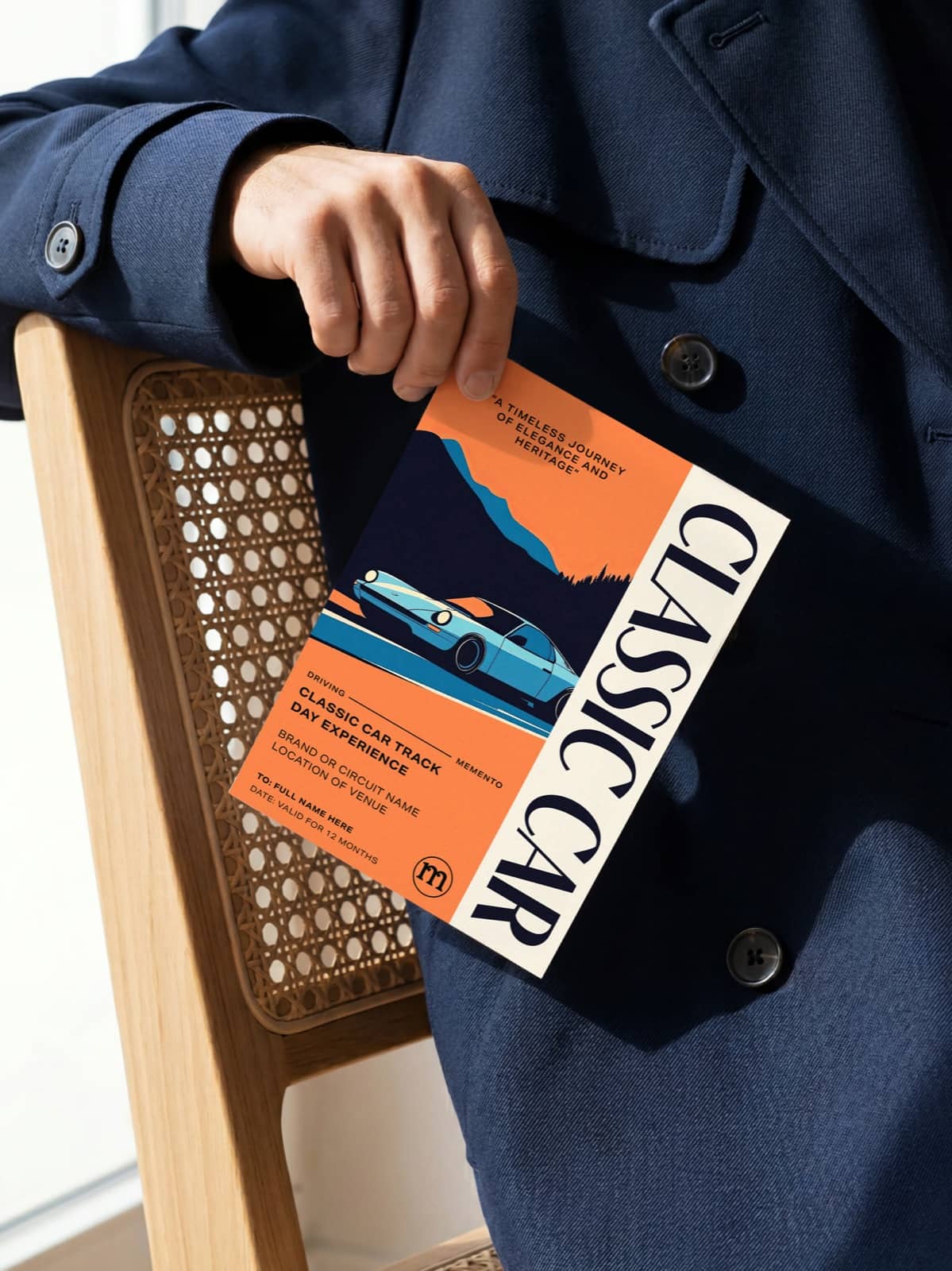 A personalised classic car experience gift keepsake ticket by Momeo held in hand.